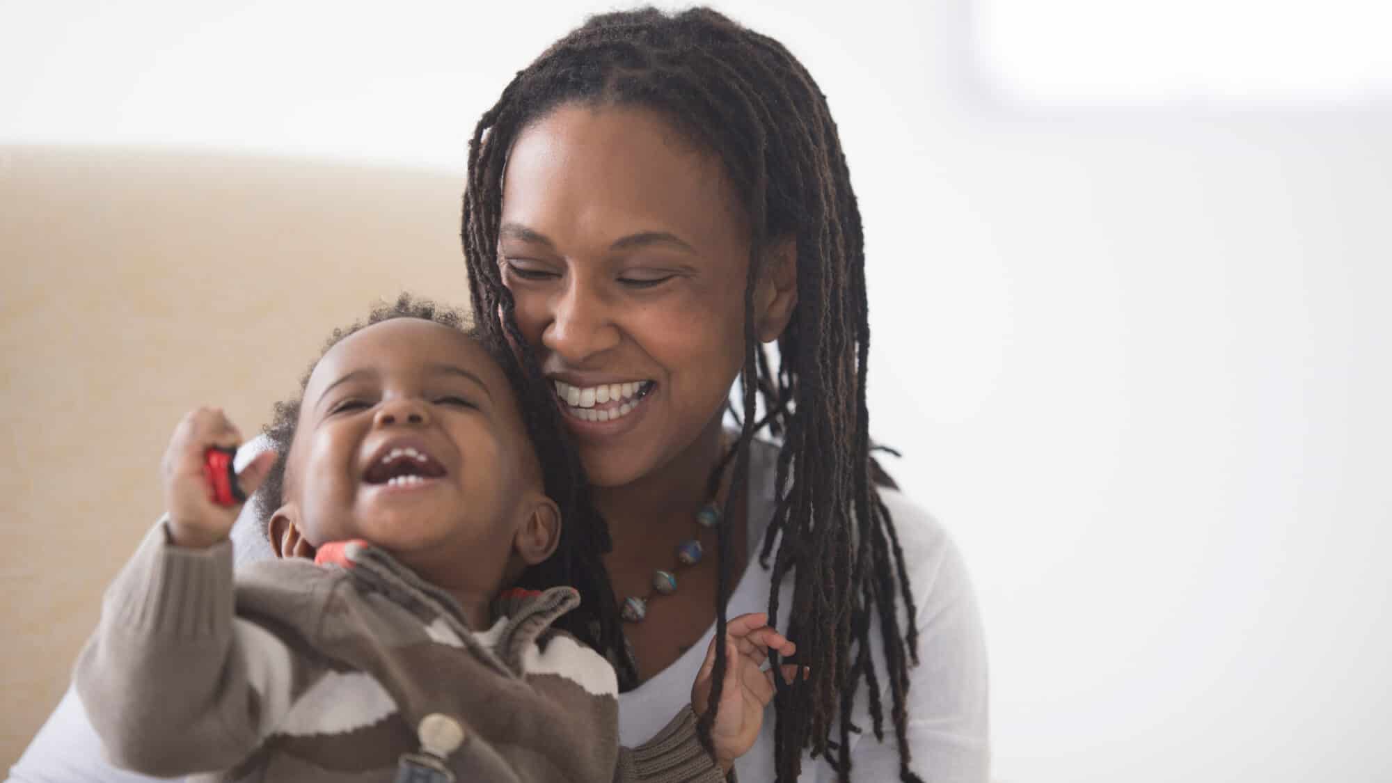 Young mother laughs and plays with her smiling daughter. Baltimore Medical System provides comprehensive healthcare to people of all ages.