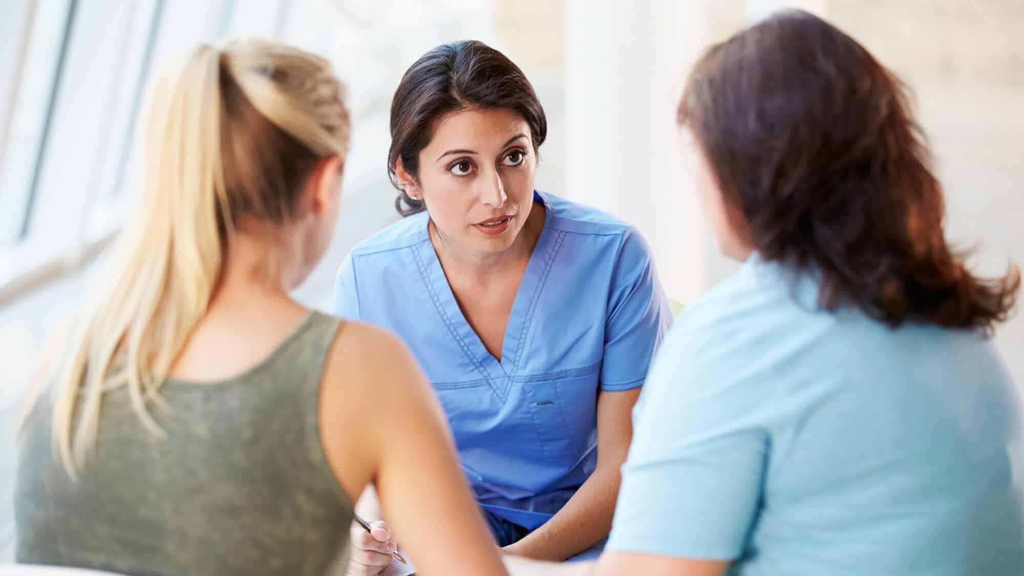 Registered Nurse offers family planning information and support to a teenager and her mother.