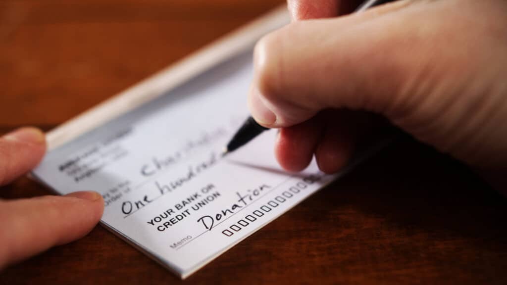 person writing a check