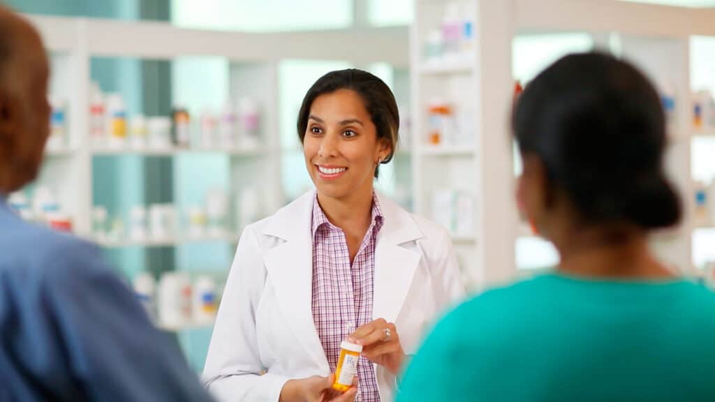 pharmacist assisting customers