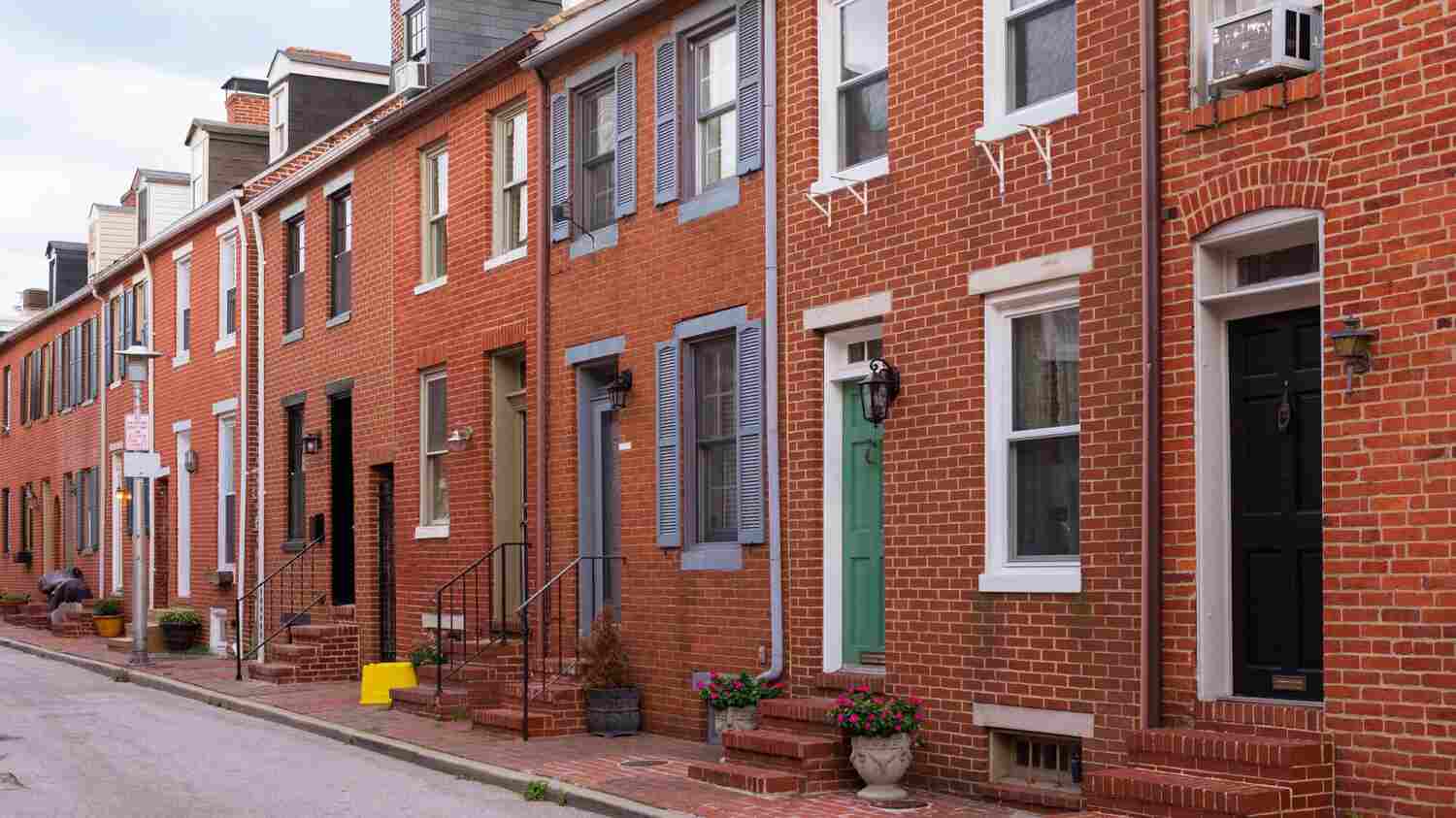 Red brick Baltimore row houses. Baltimore Medical System serves the local community.