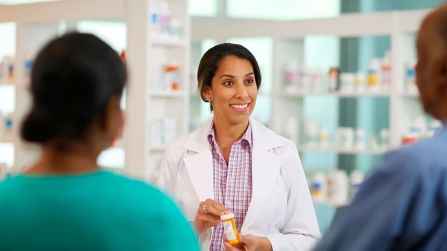 Pharmacist provides prescription explanation to a couple at a Baltimore Medical System pharmacy. 